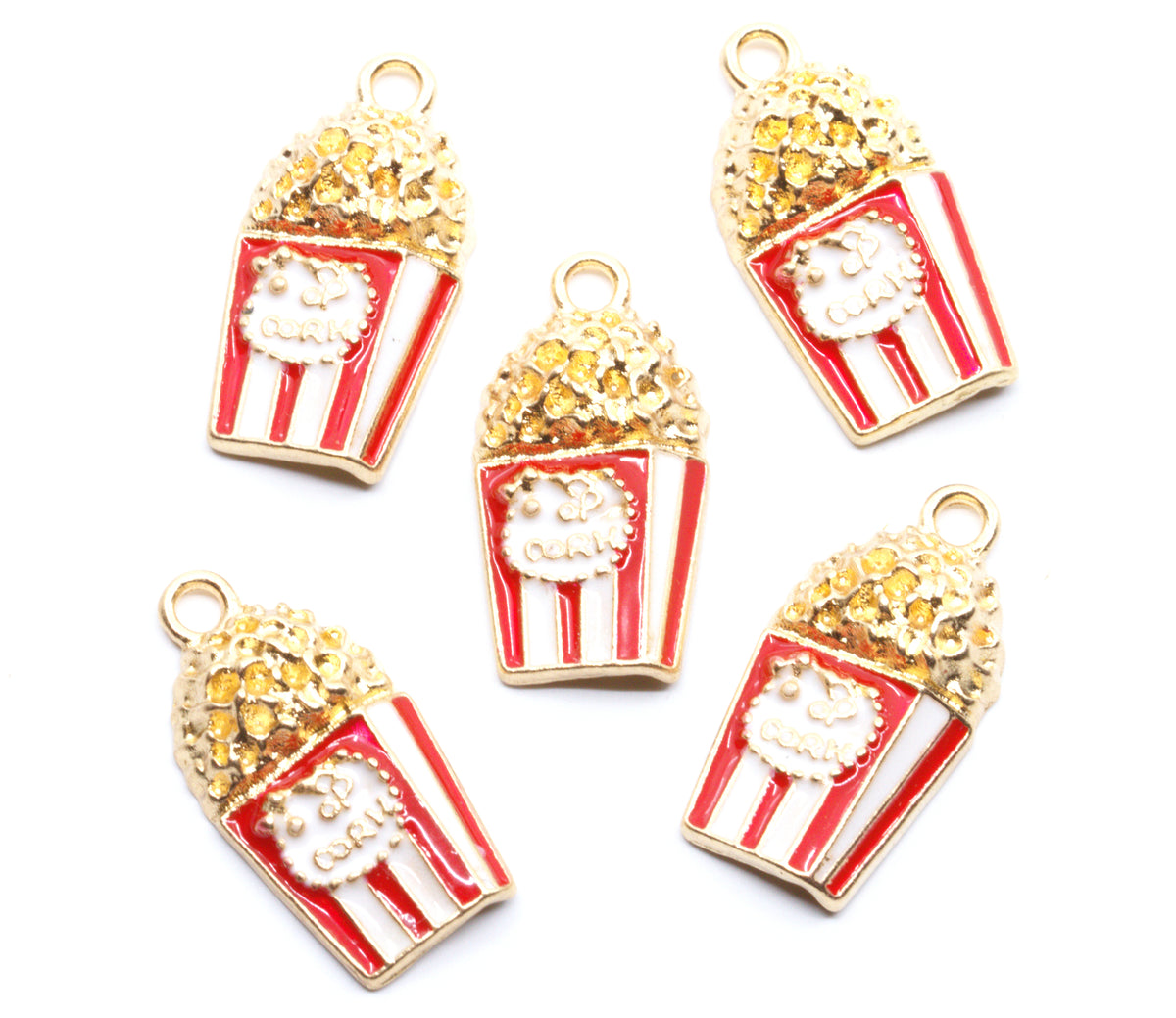 Five popcorn-shaped jewelry charms with red and white striped buckets, gold-tone outlines, and textured gold popcorn tops, arranged on a plain white background.