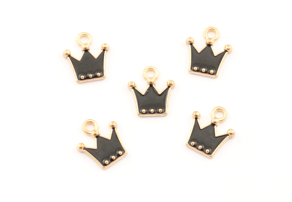 Five small crown-shaped charms with black enamel and gold-tone metal borders, arranged on a plain white background.