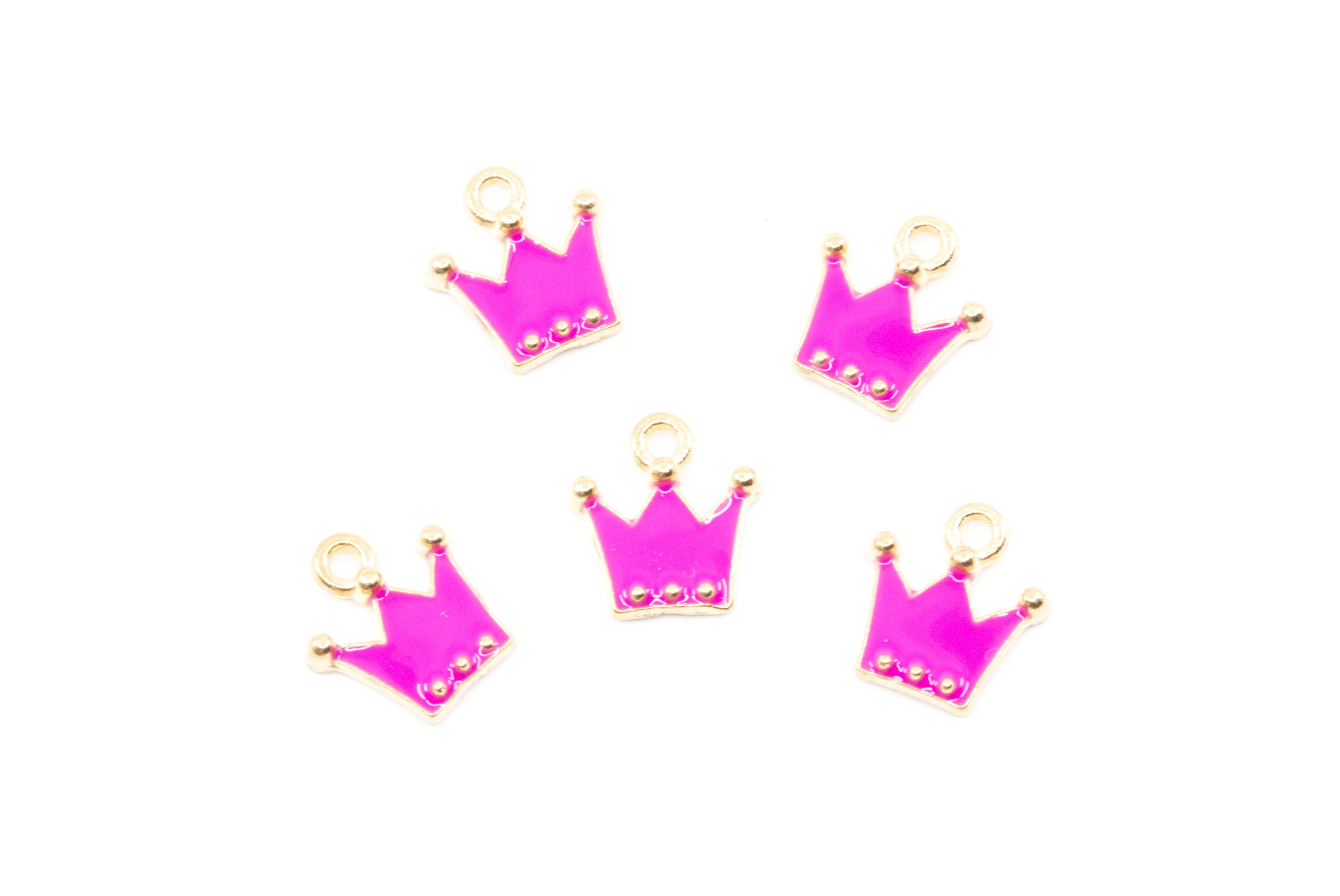 Five small crown-shaped jewelry charms in bright pink enamel with gold-tone metal borders and loops, arranged on a plain white background.