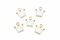 Five white crown-shaped jewelry charms with gold-tone metal borders and loops, arranged on a plain white background.
