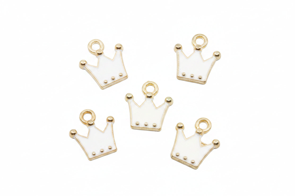 Five white crown-shaped jewelry charms with gold-tone metal borders and loops, arranged on a plain white background.