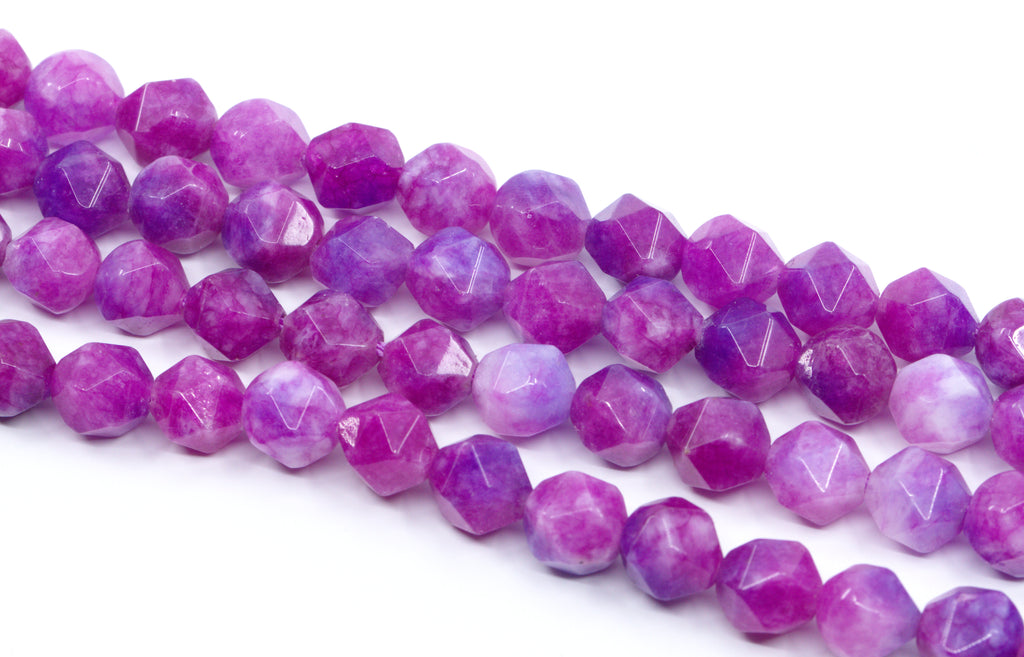 Faceted diamond cut gemstone beads in shades of purple and pink, arranged in diagonal rows on a white background.