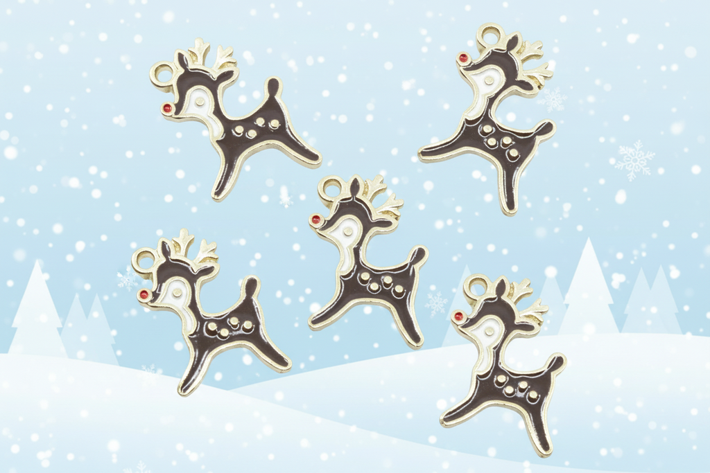 Five Christmas reindeer-shaped charms with brown enamel, gold outlines, white facial details, and red noses, arranged on a light blue snowy background with snowflakes and silhouettes of pine trees.