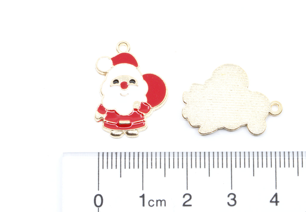 Two red and white Santa Charms and a ruler for scale on a white background.