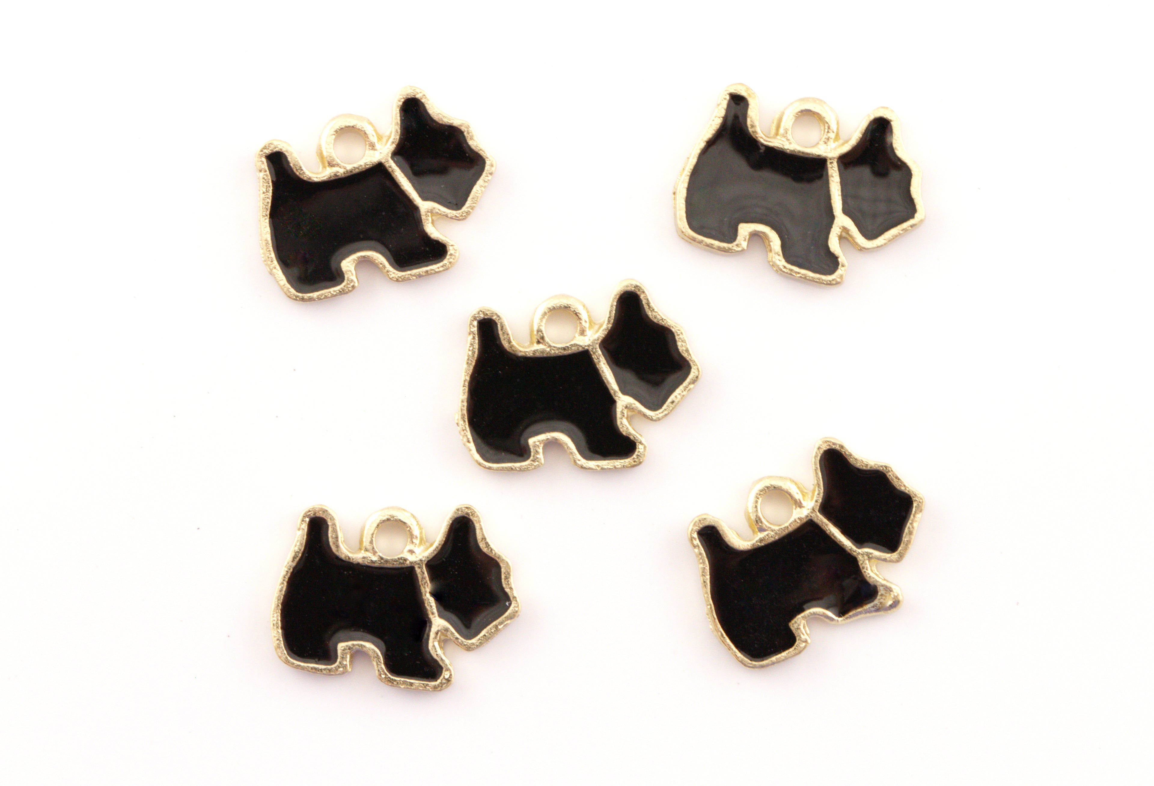 Five black and gold dog-shaped charms with small hanging loops, arranged on a plain white background.