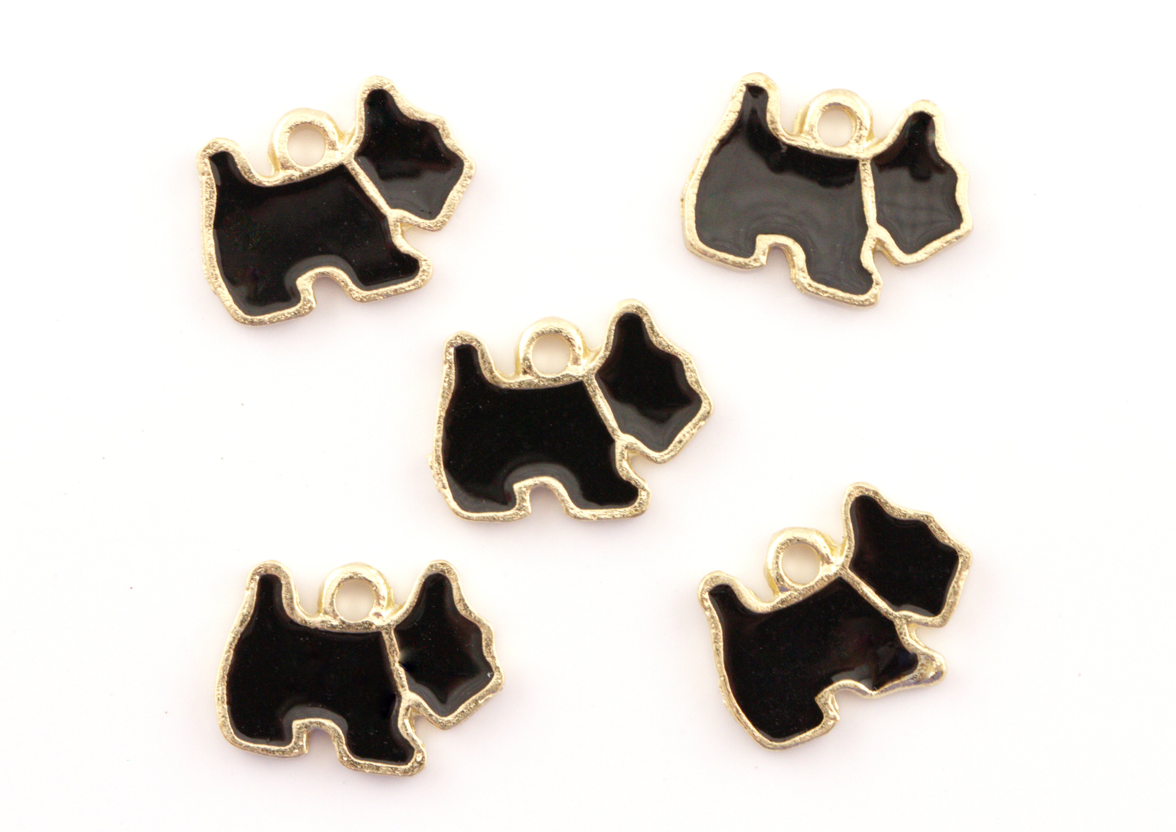Five black and gold dog-shaped charms with small hanging loops, arranged on a plain white background.