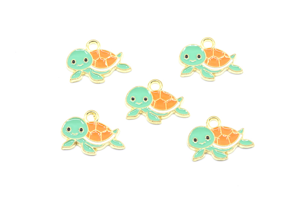 Five small turtle charms with mint green heads and flippers, orange shells, and gold-tone outlines on a plain white background.