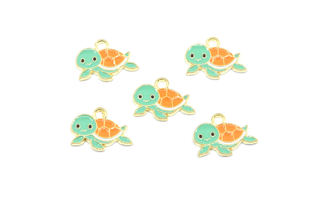 Five small turtle charms with mint green heads and flippers, orange shells, and gold-tone outlines on a plain white background.