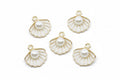 Five gold-plated white shell charms with white faux pearl centers, arranged on a white background.