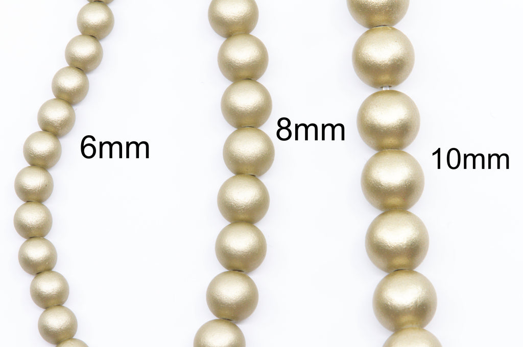 three strand of gold shimmer acrylic beads with the texts 6mm, 8mm and 10mm shown to indicate size on a white background 
