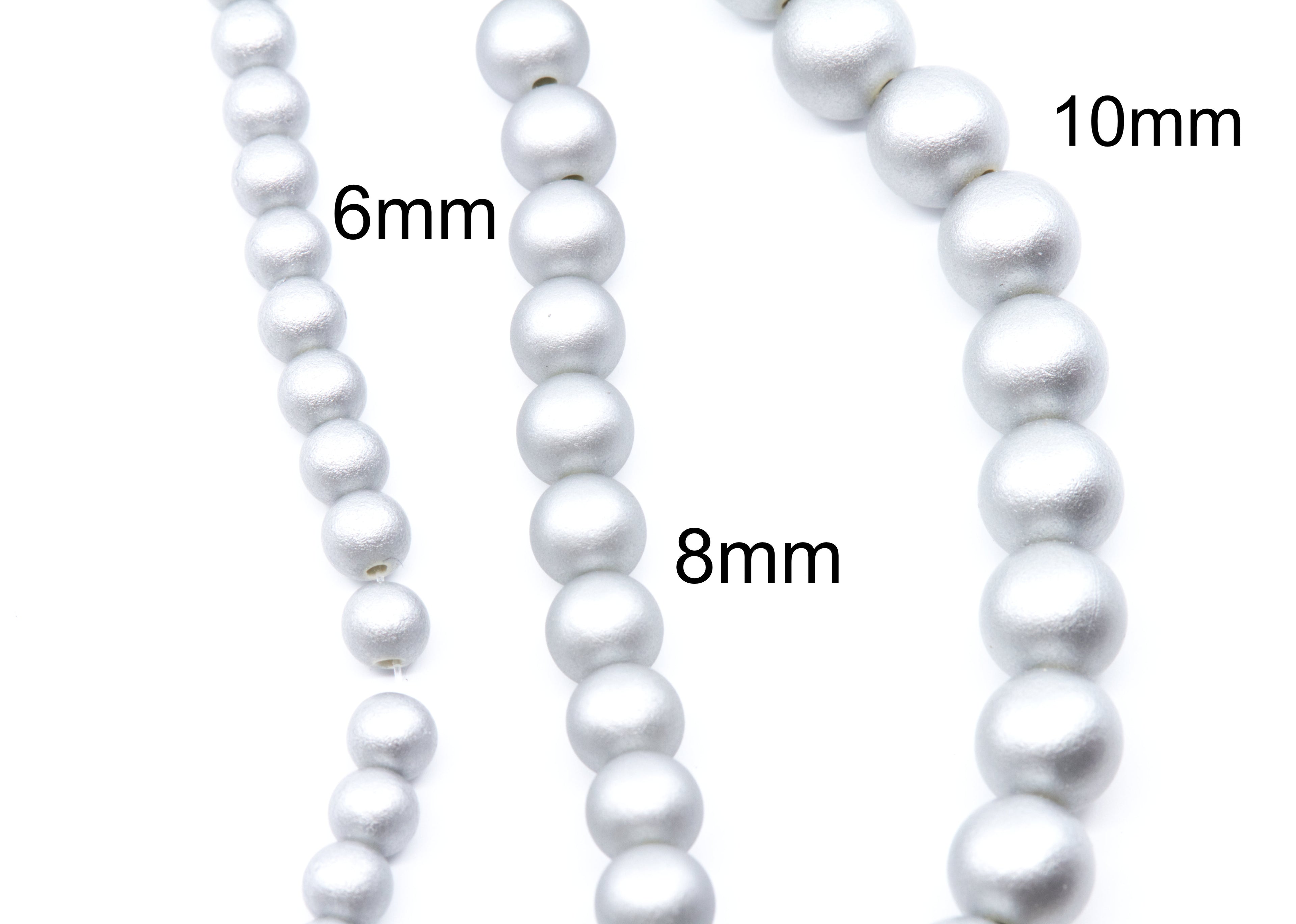 Three strands of silver shimmery acrylic  beads shown on a white background, labeled with sizes 6mm, 8mm, and 10mm.