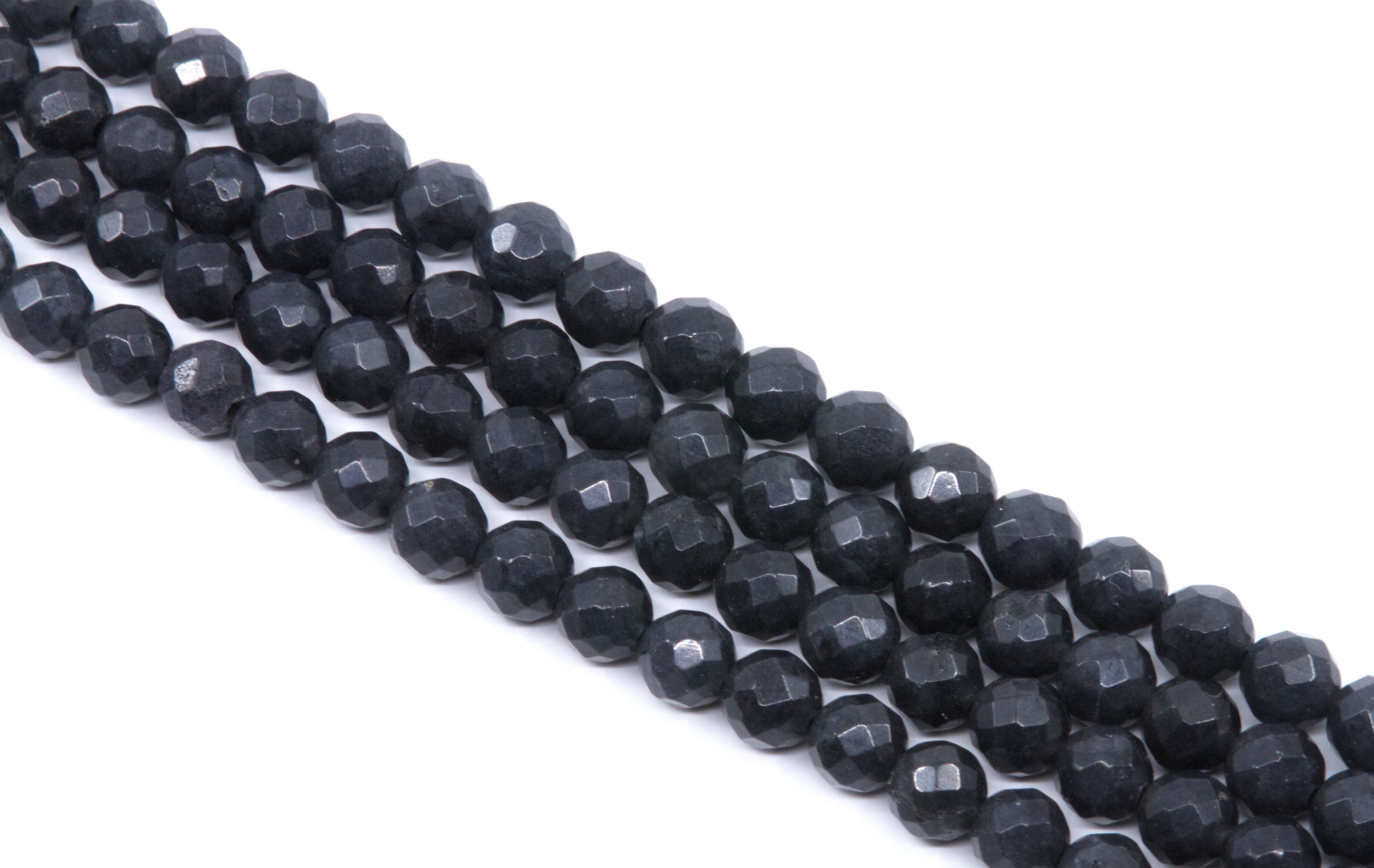 Faceted dark gray agate beads arranged in diagonal rows on a plain white background.