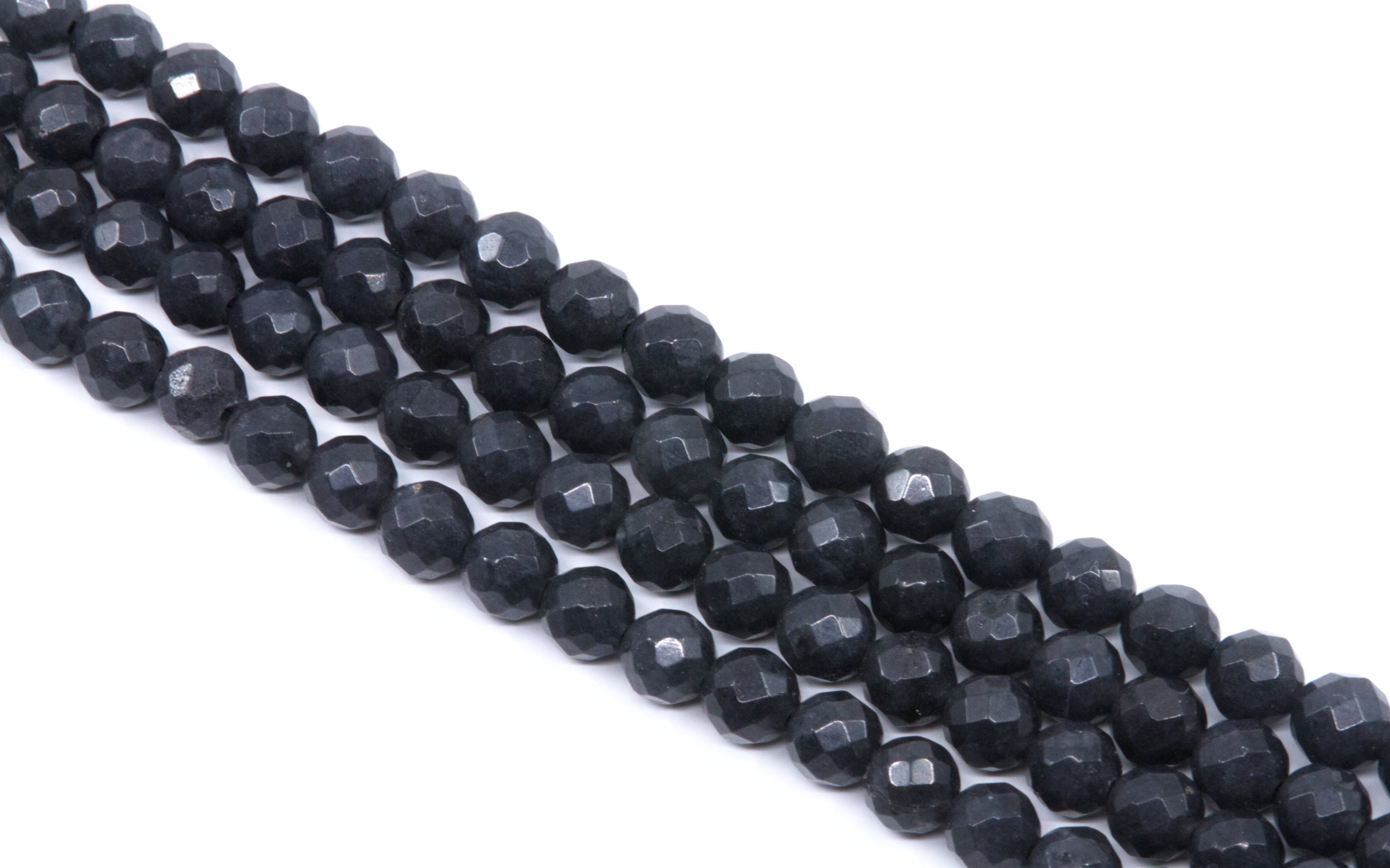 Faceted dark gray agate beads arranged in diagonal rows on a plain white background.