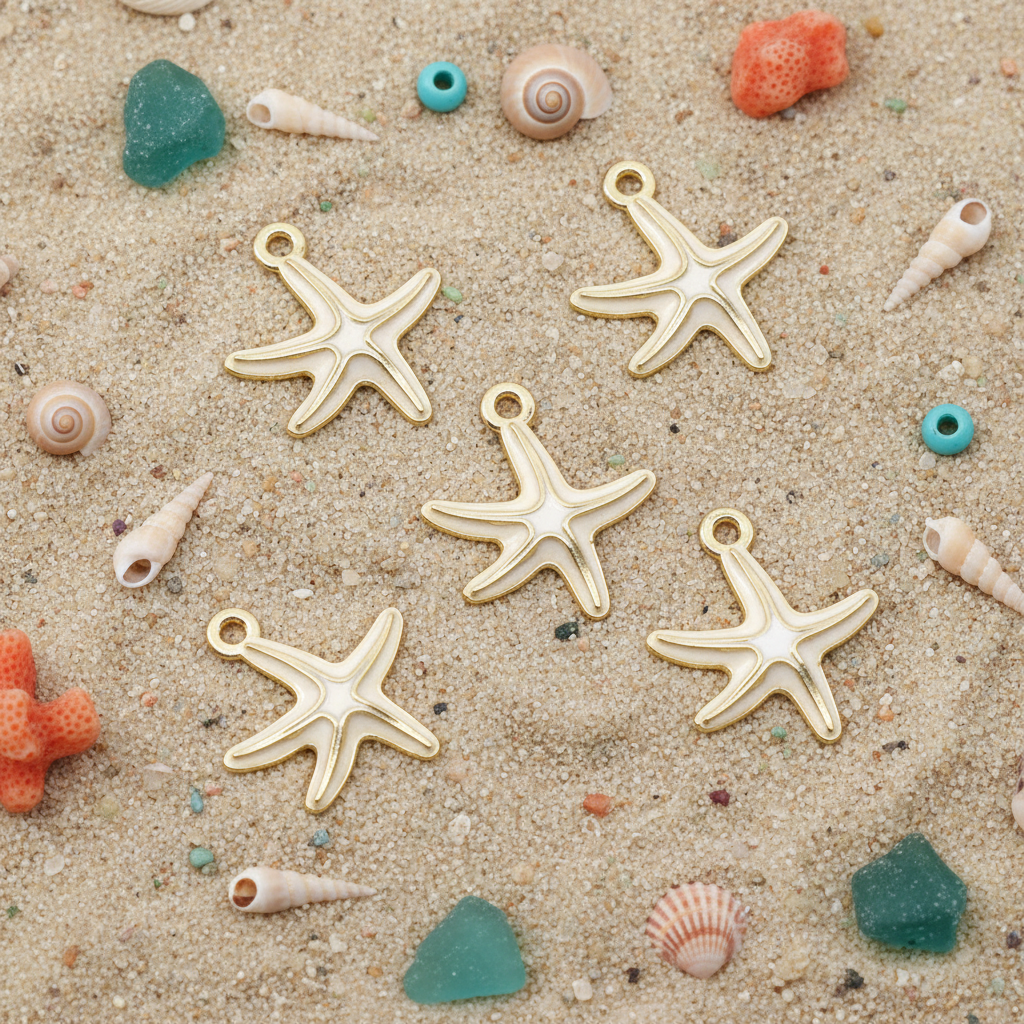 Five white and cream starfish-shaped jewelry charms arranged on a sandy surface with small seashells, coral pieces, and turquoise beads around them.