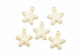 Five small starfish-shaped jewelry charms with cream enamel and gold-tone edges, arranged on a white background.