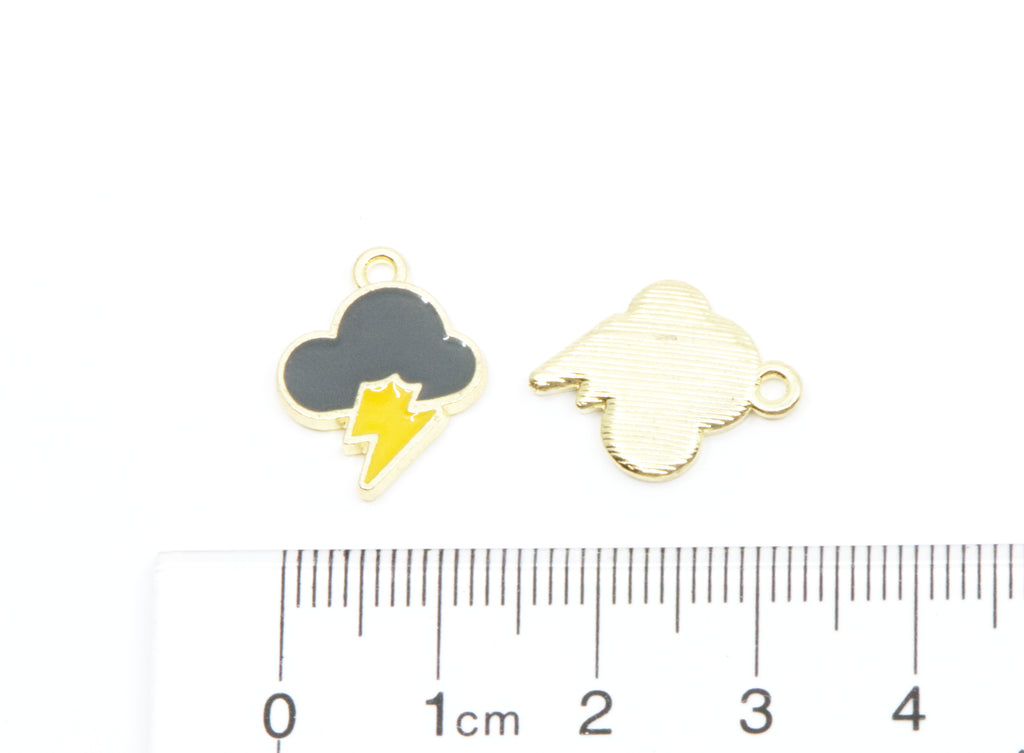 Two small cloud-shaped jewelry charms with a lightning bolt design, shown on a white background above a ruler for scale. 