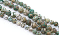 Four strands of round Tibetan agate beads  with a  pattern of green, brown, gray, and white, arranged diagonally on a white background.