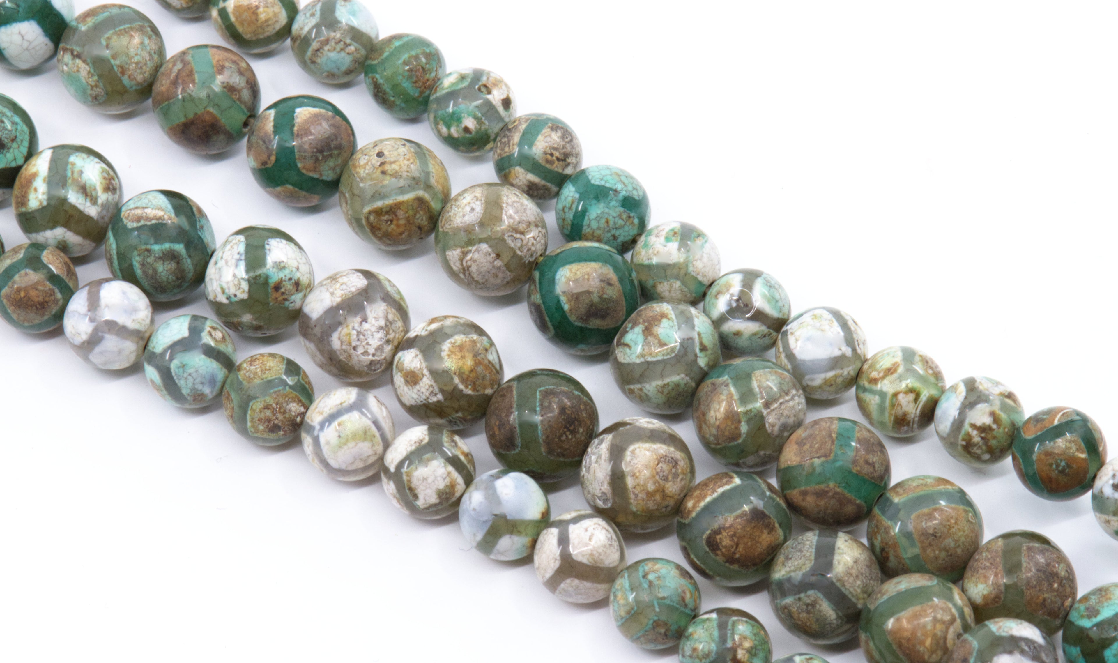 Four strands of round Tibetan agate beads  with a  pattern of green, brown, gray, and white, arranged diagonally on a white background.