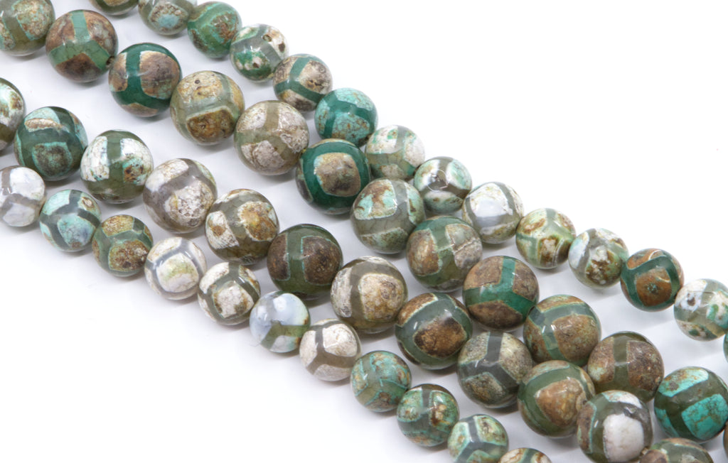 Four strands of round Tibetan agate beads  with a  pattern of green, brown, gray, and white, arranged diagonally on a white background.