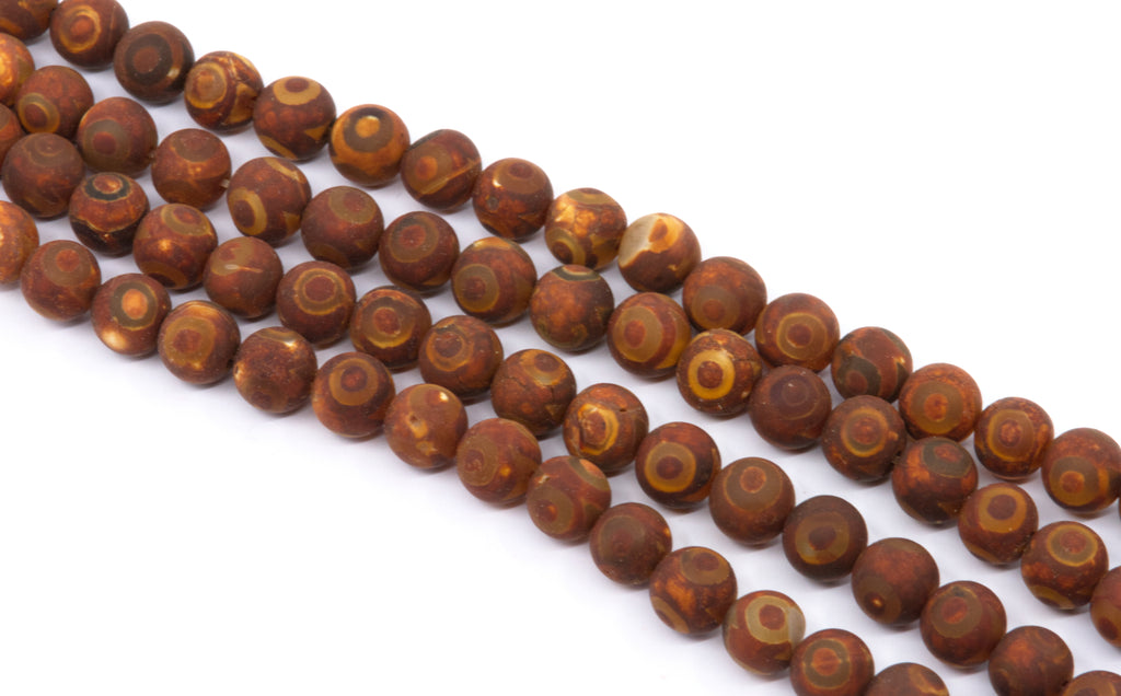 four strands of round brown-red beads with natural concentric ring patterns, displayed diagonally on a white background.