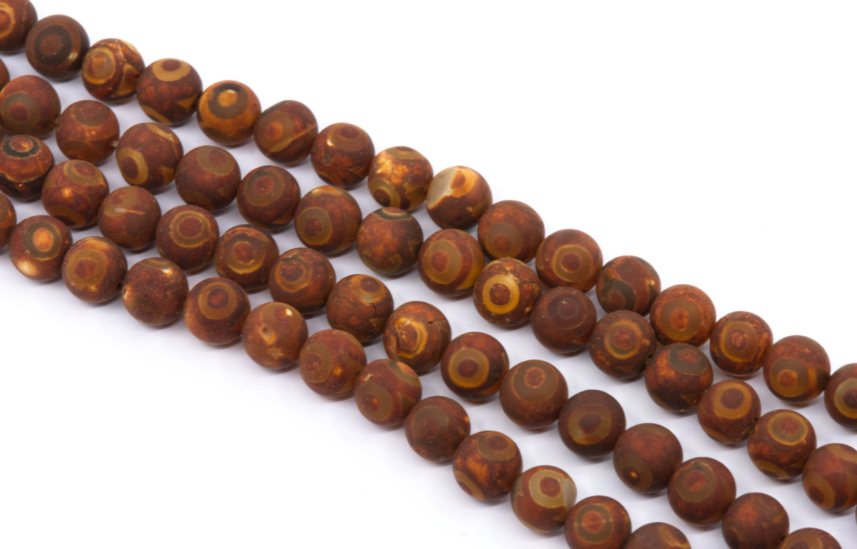 four strands of round brown-red beads with natural concentric ring patterns, displayed diagonally on a white background.
