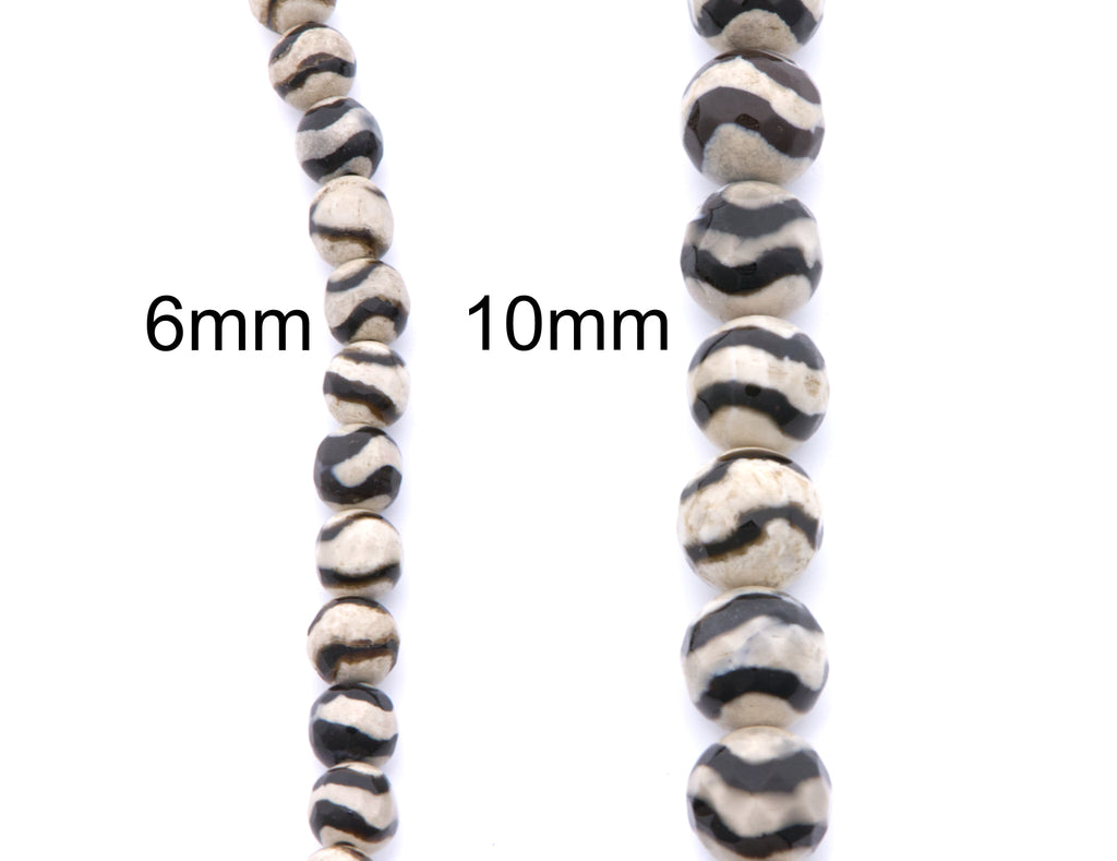 Two strands of round beads with a black and off-white zebra-stripe pattern, labeled 6mm and 10mm, on a plain white background.