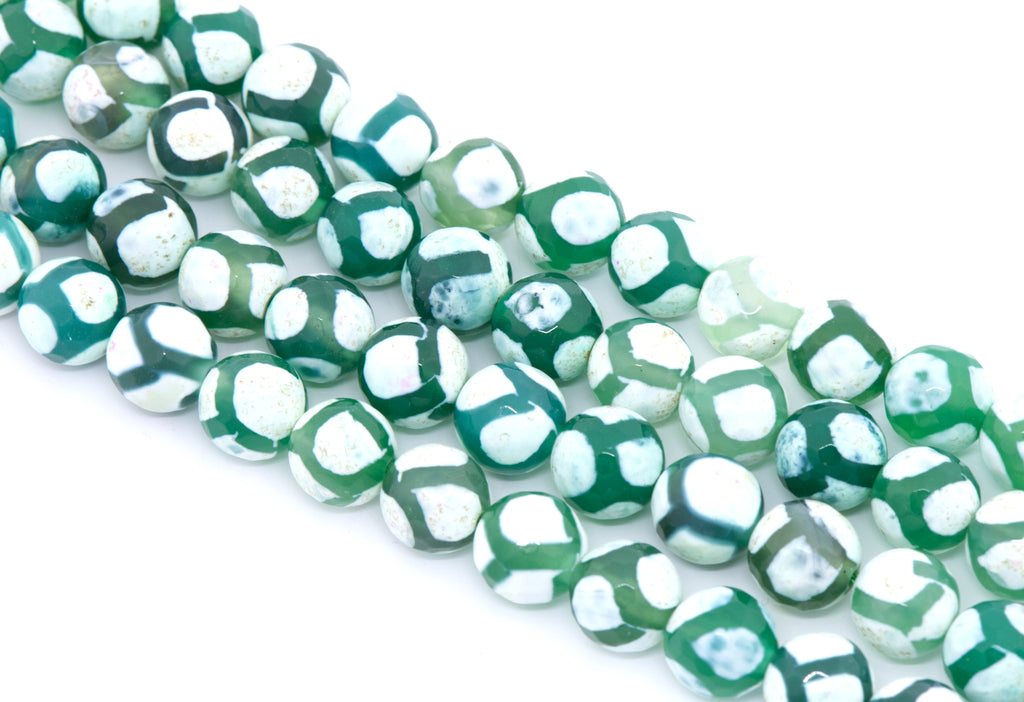Green and white round Tibetan agate beads arranged diagonally on a clean white background.