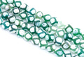 Green and white round Tibetan agate beads arranged diagonally on a clean white background.
