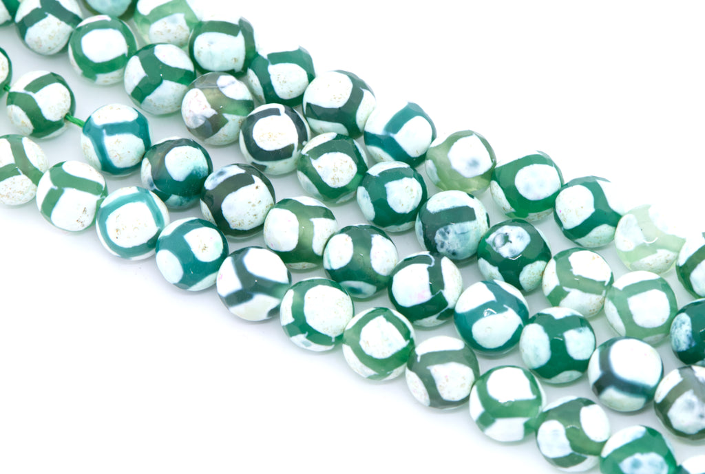 Green and white round Tibetan agate beads arranged diagonally on a clean white background.
