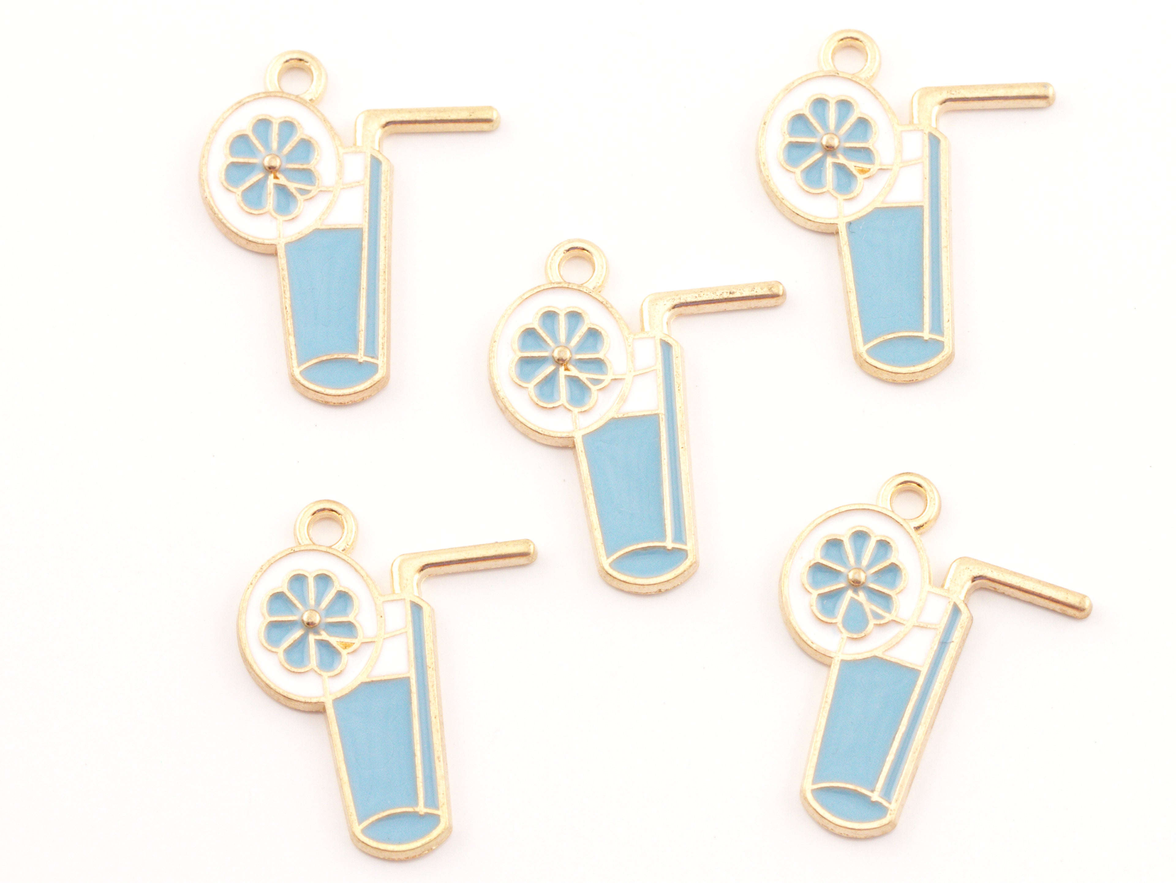 Five enamel blue tropical drink charms with  garnish and a straw, shown on a plain white background.