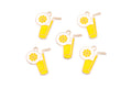 Five enamel charms shaped like yellow lemonade glasses with straws, garnished with a lemon wheel, arranged on a plain white background.