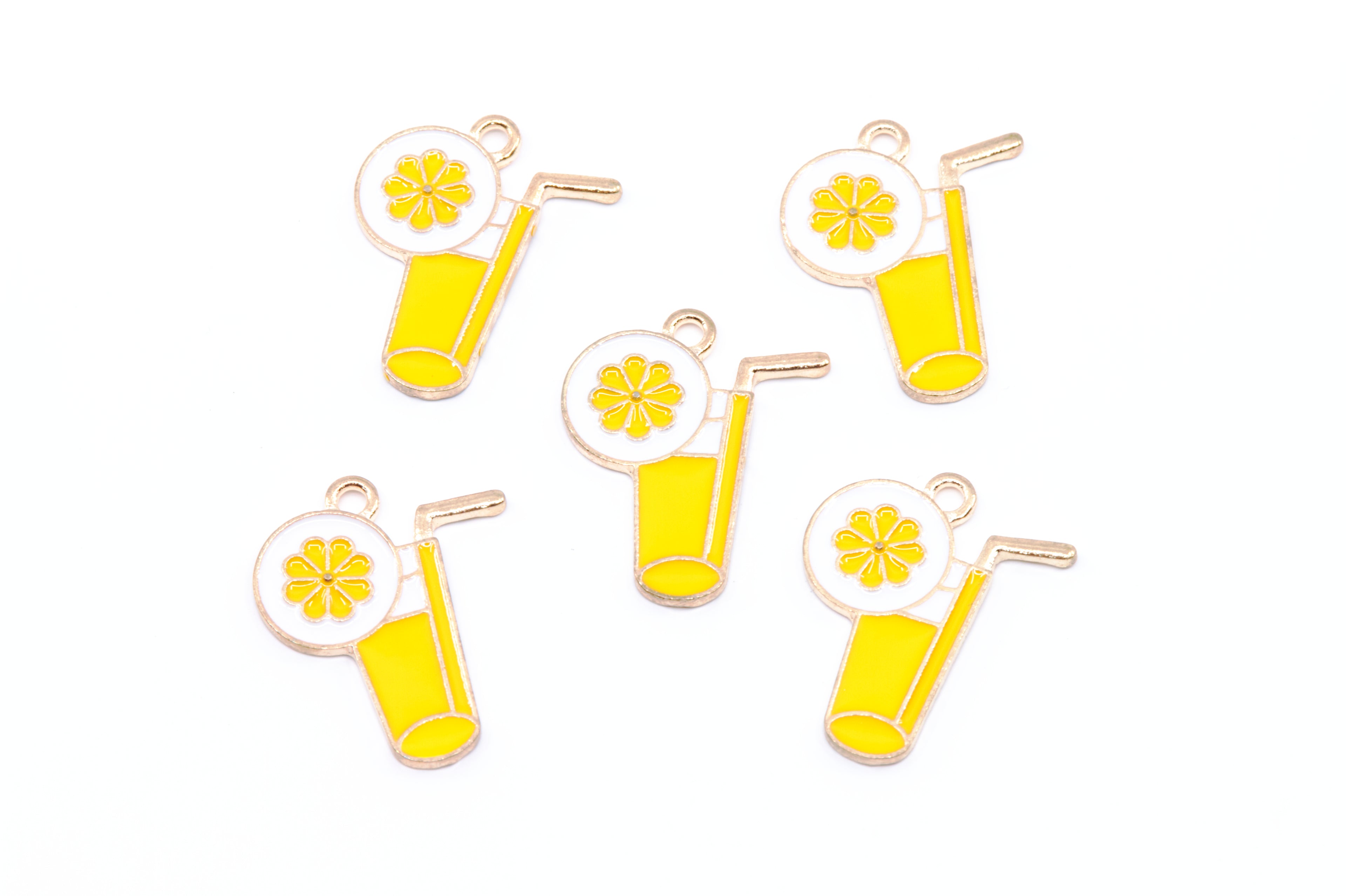 Five enamel charms shaped like yellow lemonade glasses with straws, garnished with a lemon wheel, arranged on a plain white background.
