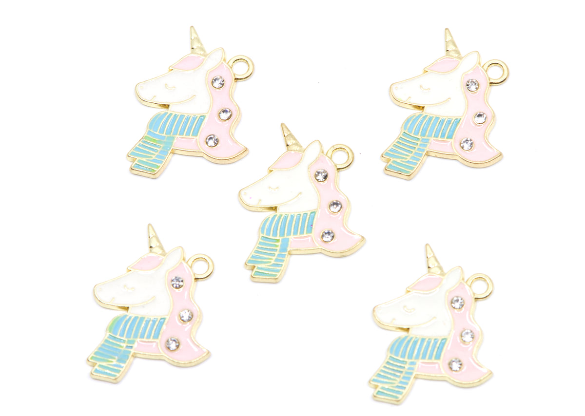 Five identical unicorn-shaped charms with gold-tone metal borders, pastel pink and white enamel, light blue striped scarves, and small clear rhinestones, arranged on a plain white background.