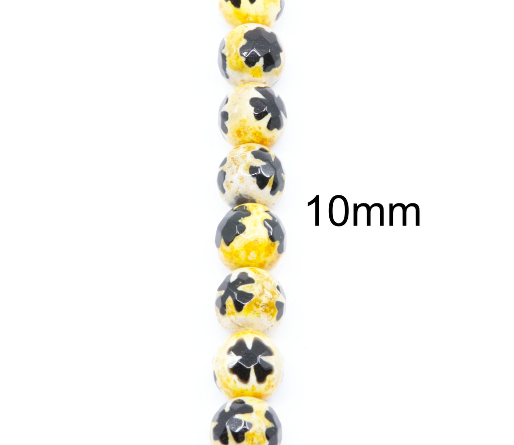A vertical strand of round beads, each 10mm in diameter, featuring a glossy yellow base with blue clover design on top, shown on a plain white background with a '10mm' size label.